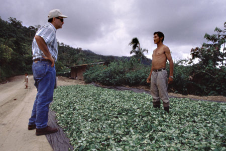 USAID officer speaks with a coca farmer in the Apurimac River Valley area, Peru