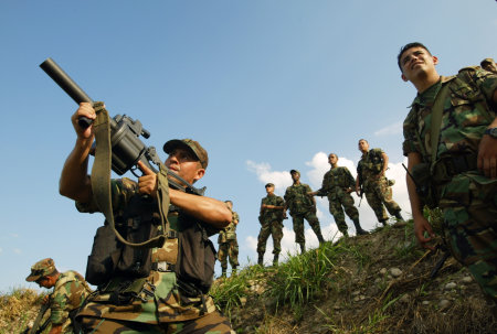 U.S. Special Forces training Colombian soldiers on the use of new firearms. Saravena, Colombia.