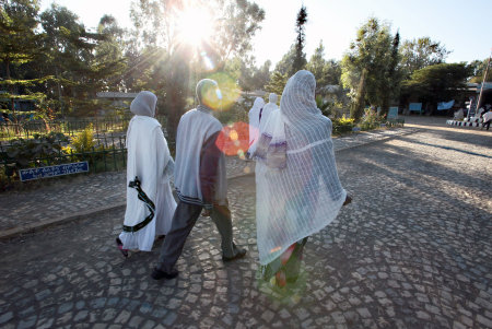 Gebretsahme WeldeSelase  Is having cataract surgery in both eyes today, at St. Mary's Aksum Hospital. he and hundreds of other patients have been scheduled today for cataract surgery. 
On the hospital grounds, he walks with his wife Amsale and another relative to the scheduled patient waiting area.